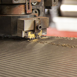A specialty tool recorrugates a roller mill roll.